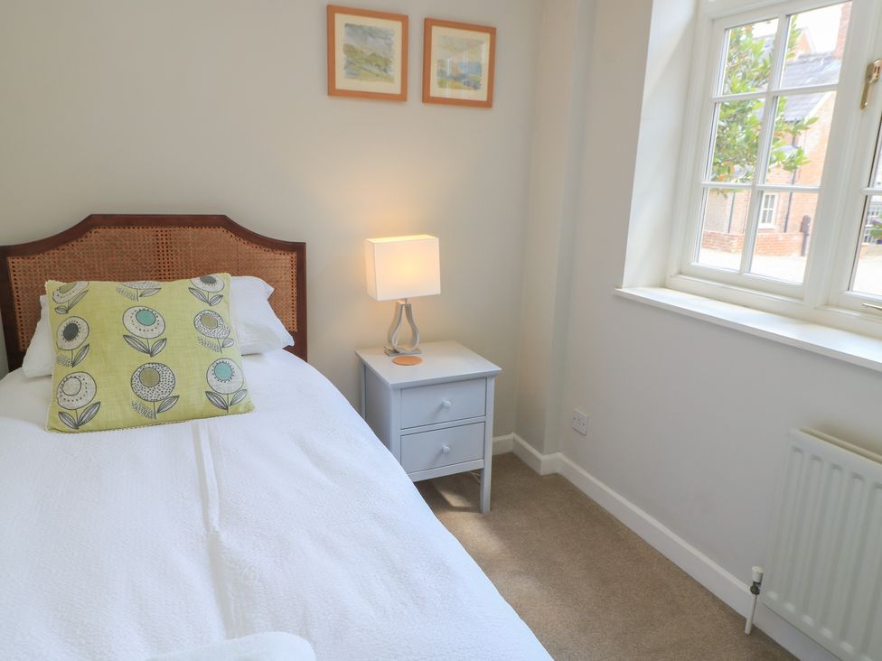A bedroom with a bed and nightstand at The Cider Press, Motcombe