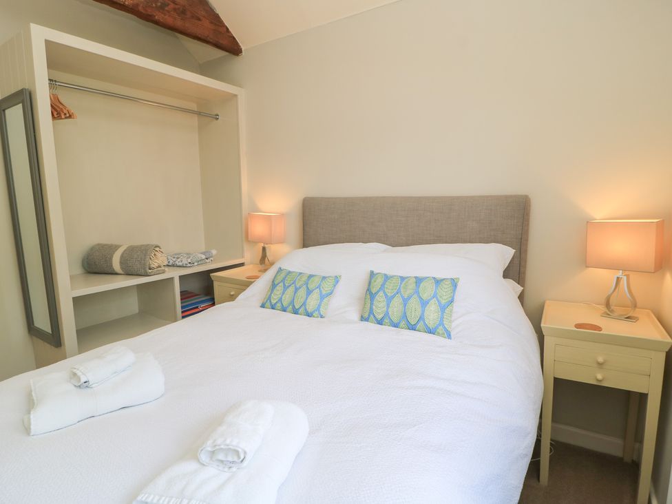 A bedroom with a double bed and bedside table at The Cider Press, Motcombe