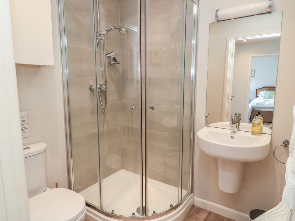 A bathroom with a shower, toilet and sink at The Cider Press, Motcombe