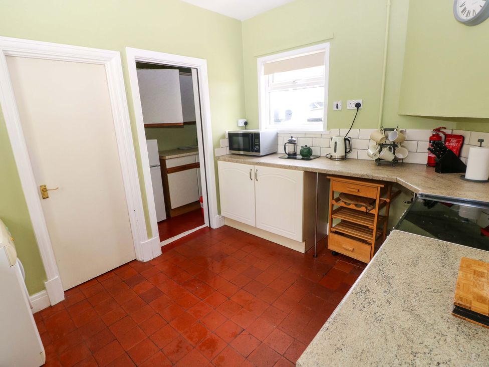 A kitchen with appliances and cabinets at White Thorns in Haverfordwest