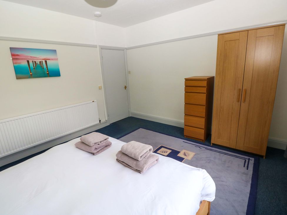 A bedroom with a bed and furniture at White Thorns in Haverfordwest