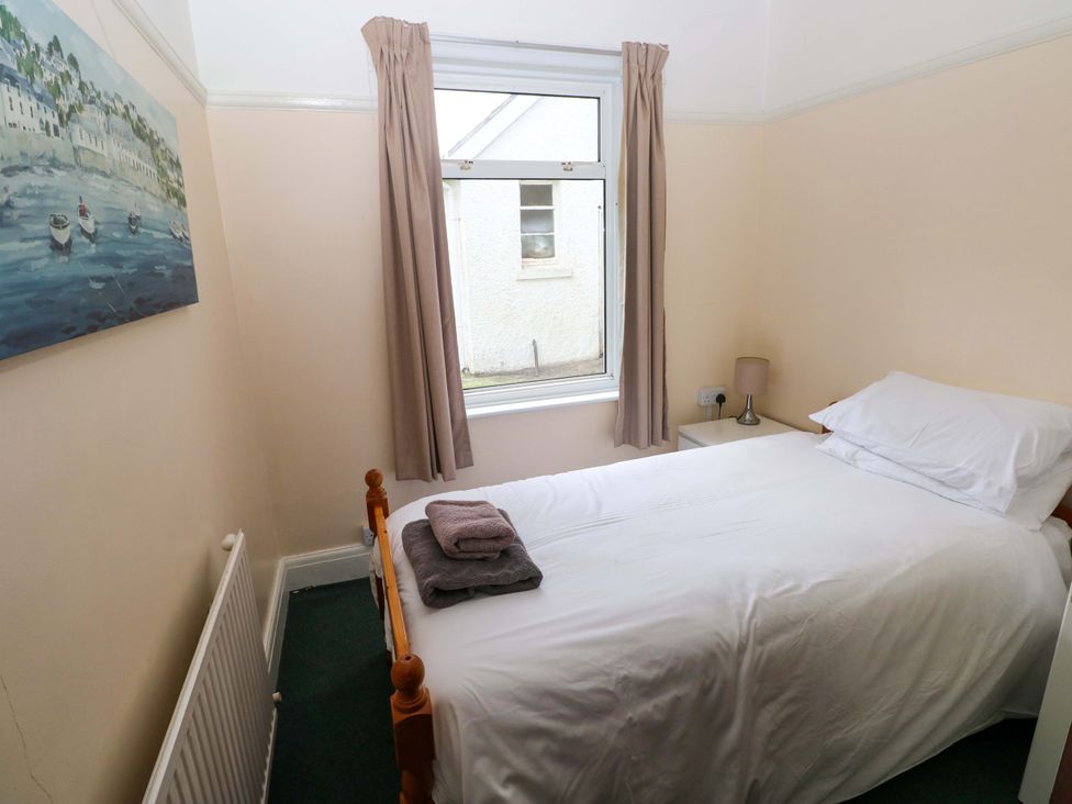A bedroom with a bed and a window at White Thorns in Haverfordwest