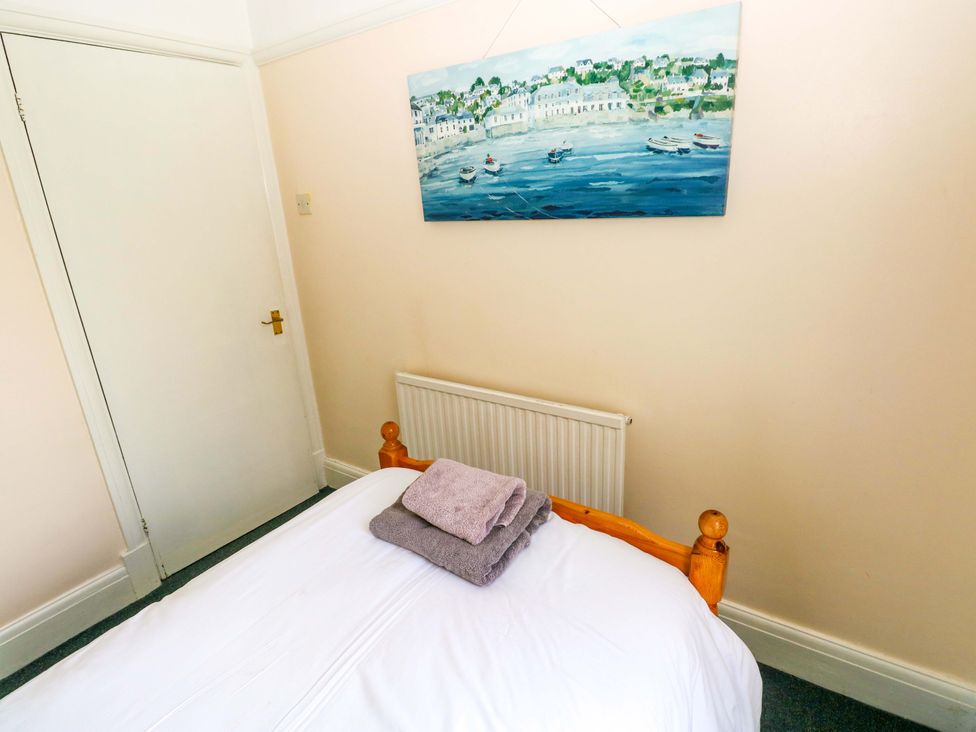 A bedroom with a bed and towels on a blanket at White Thorns in Haverfordwest