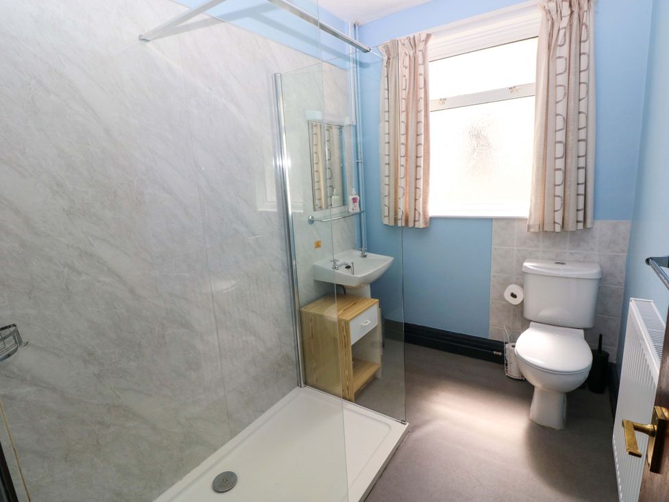 A bathroom with a shower, sink, and toilet at White Thorns in Haverfordwest