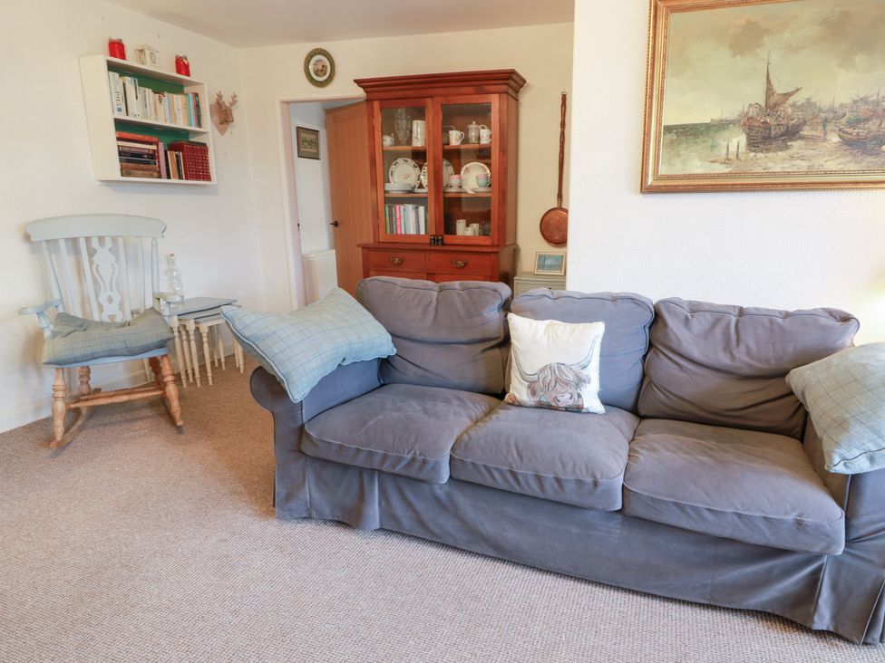 A living room with a sofa and armchair at Charlies Cottage in Swinton