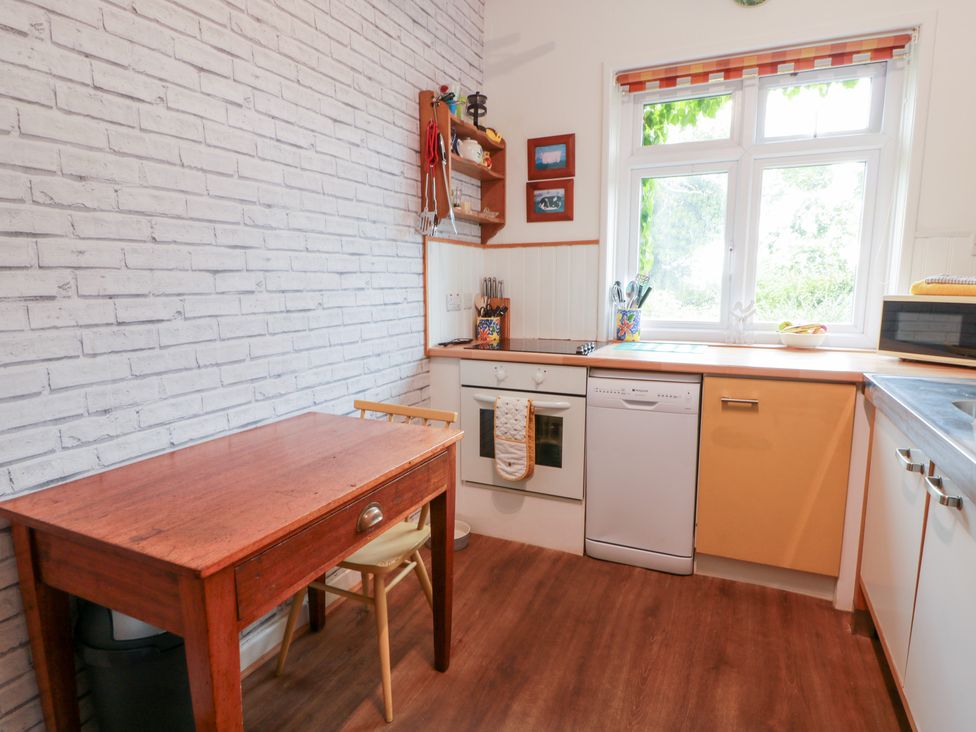 A kitchen with a table and chairs at Charlies Cottage in Swinton