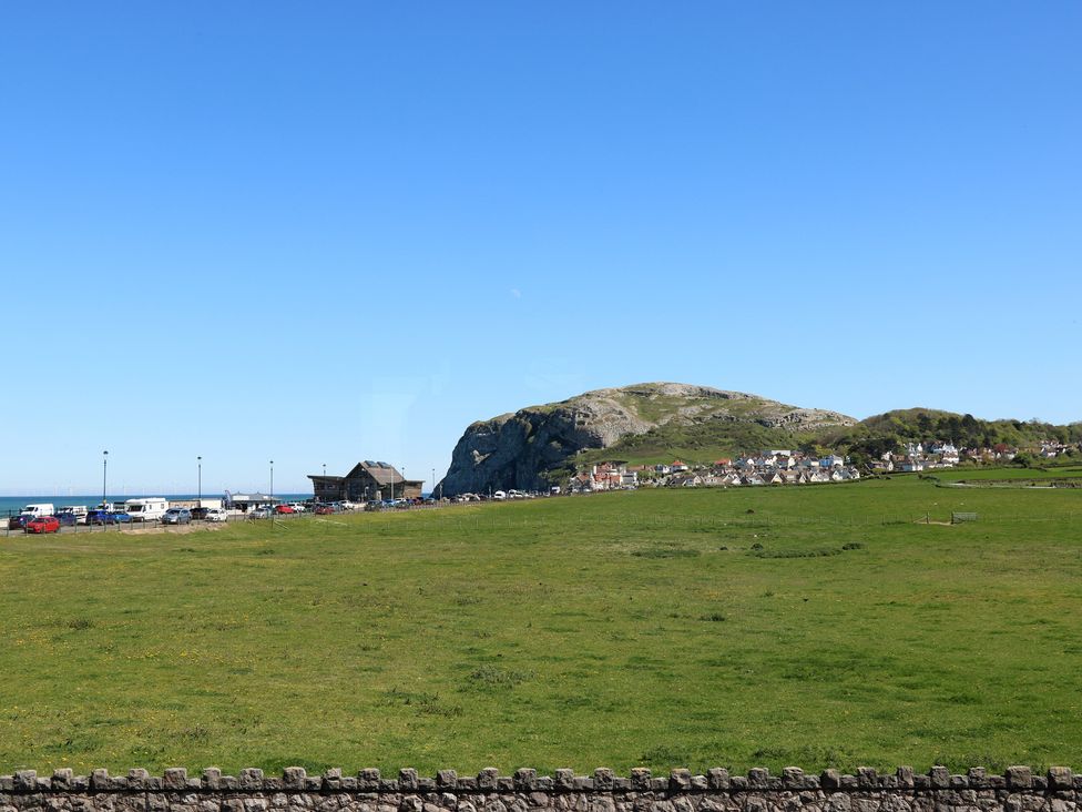 A landscape view with a mountain and houses at Little Orme View in Llandudno