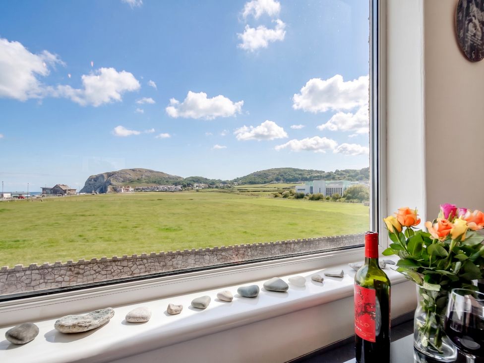 A room with a view featuring rocks on the windowsill at Little Orme View Llandudno