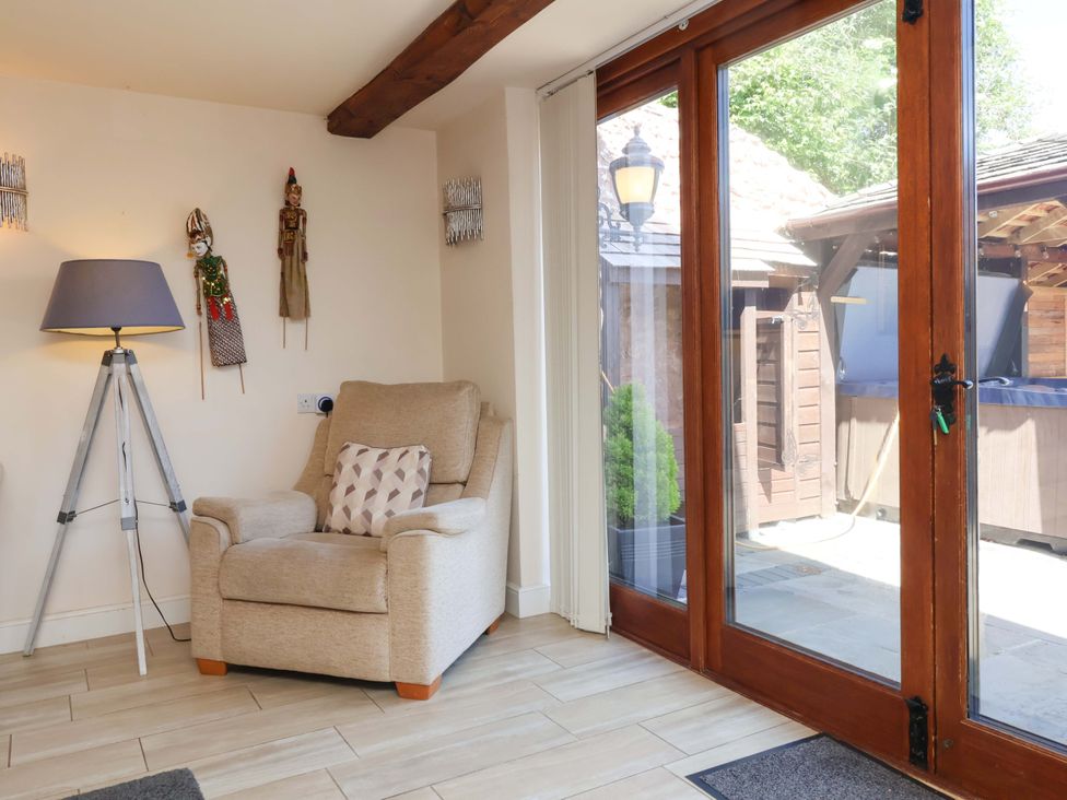 A snug with an armchair and lamp at The Linhay Washford near Watchet