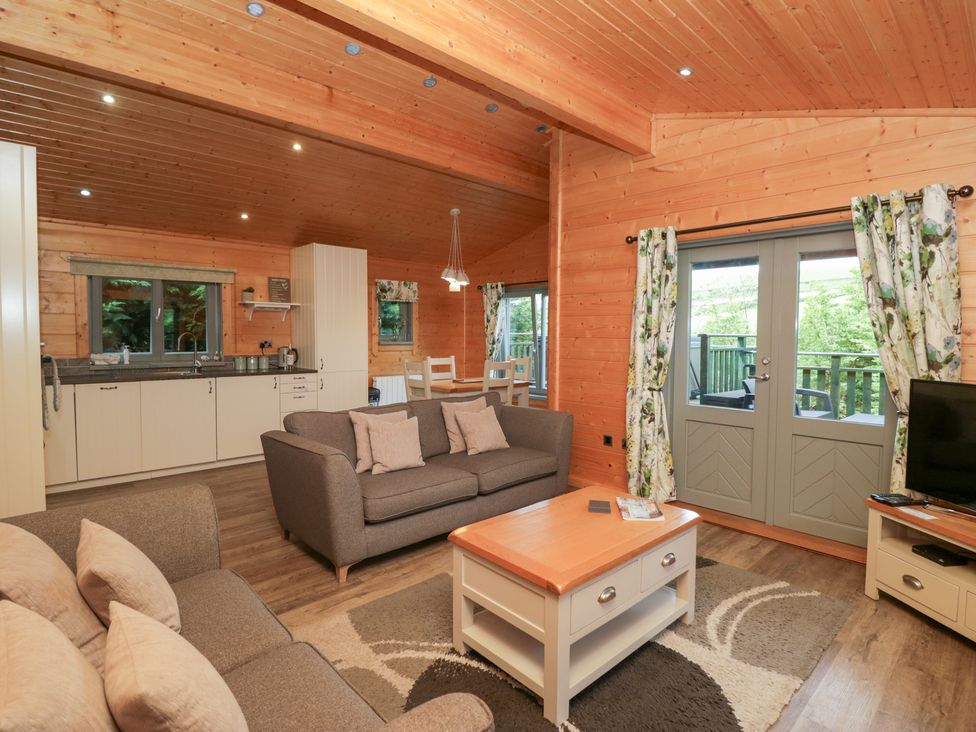 A living room with a sofa and coffee table at Elm Lodge in Ulverston