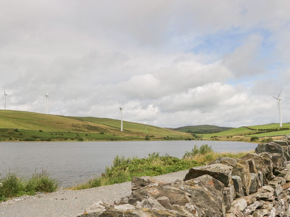 A landscape with wind turbines and a lake at Elm Lodge in Ulverston