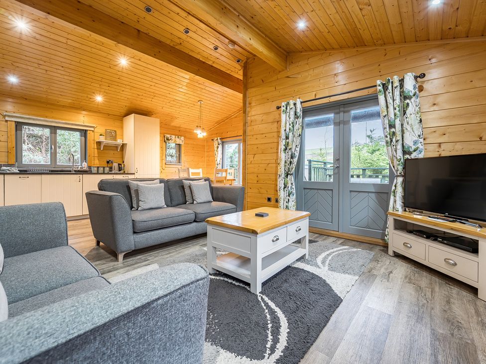 A living room with a sofa and coffee table at Elm Lodge in Ulverston