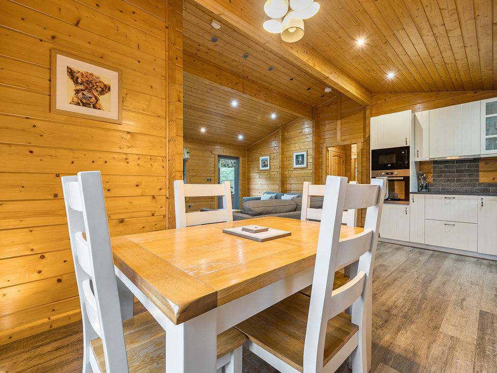A dining area with a table and chairs at Elm Lodge in Ulverston