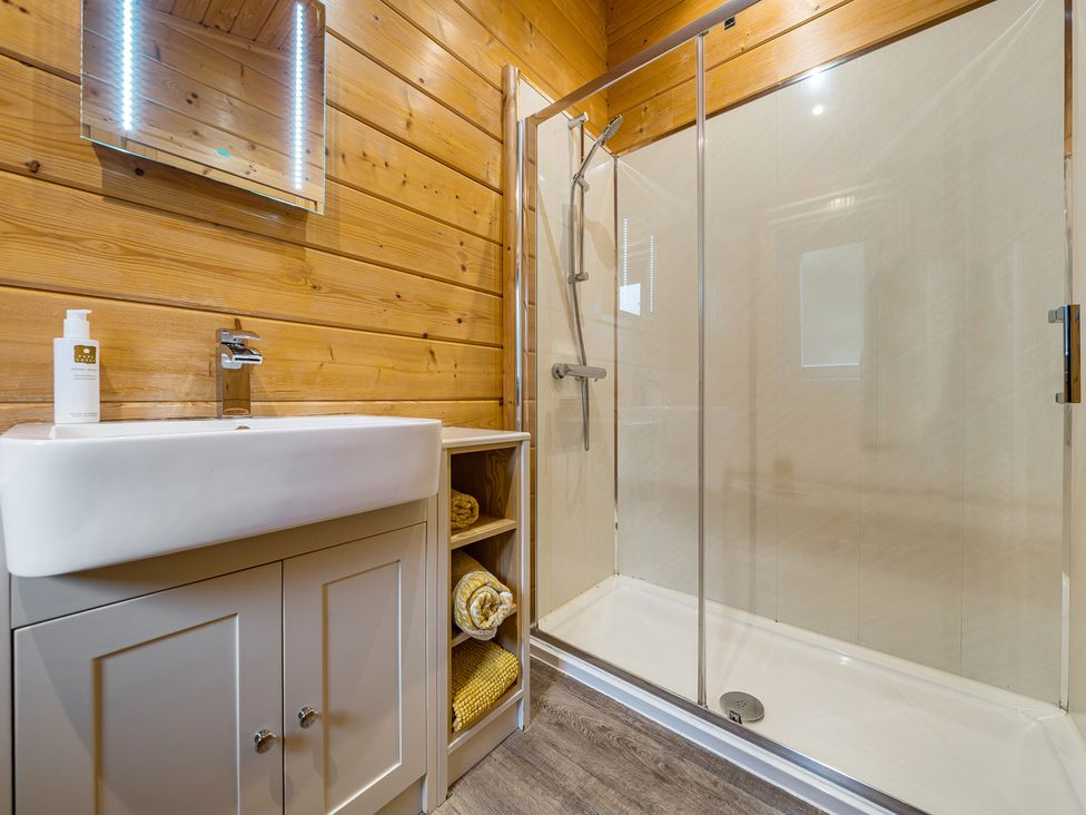 A bathroom with a sink and shower at Elm Lodge, Ulverston