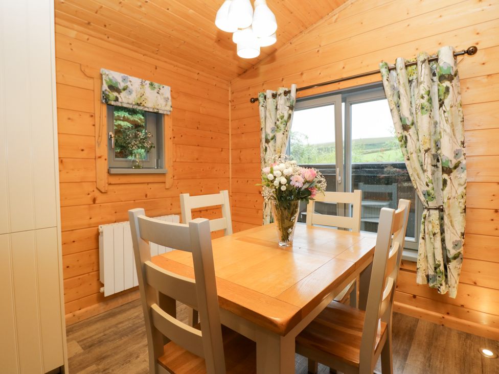A dining room with a table and chairs at Elm Lodge in Ulverston
