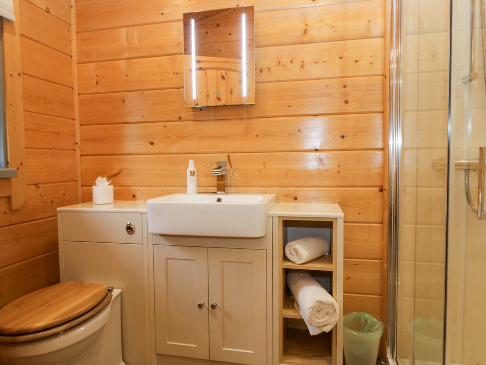 A bathroom with a sink and mirror at Elm Lodge in Ulverston