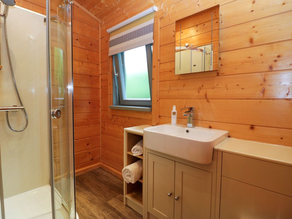 A bathroom with a shower and sink at Elm Lodge in Ulverston