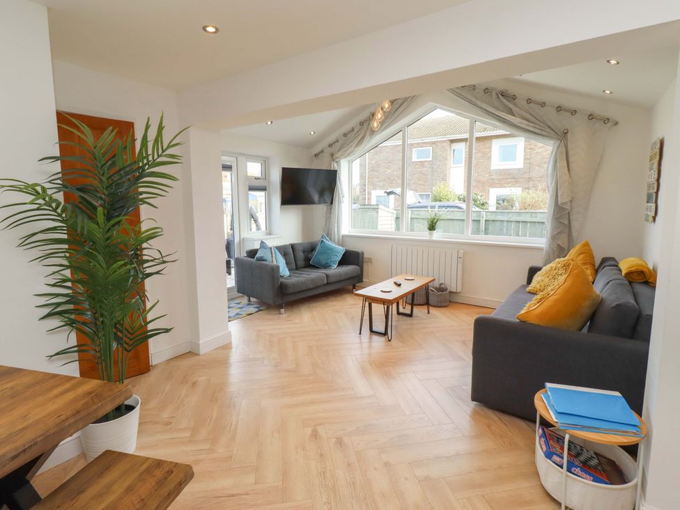 A living room with sofas and a coffee table at Sunrise Cottage Beadnell