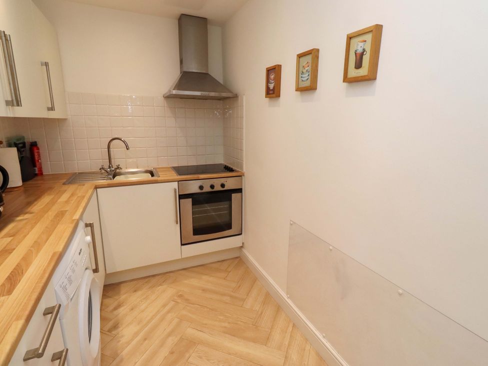 A kitchen with a sink and stove at Sunrise Cottage in Beadnell