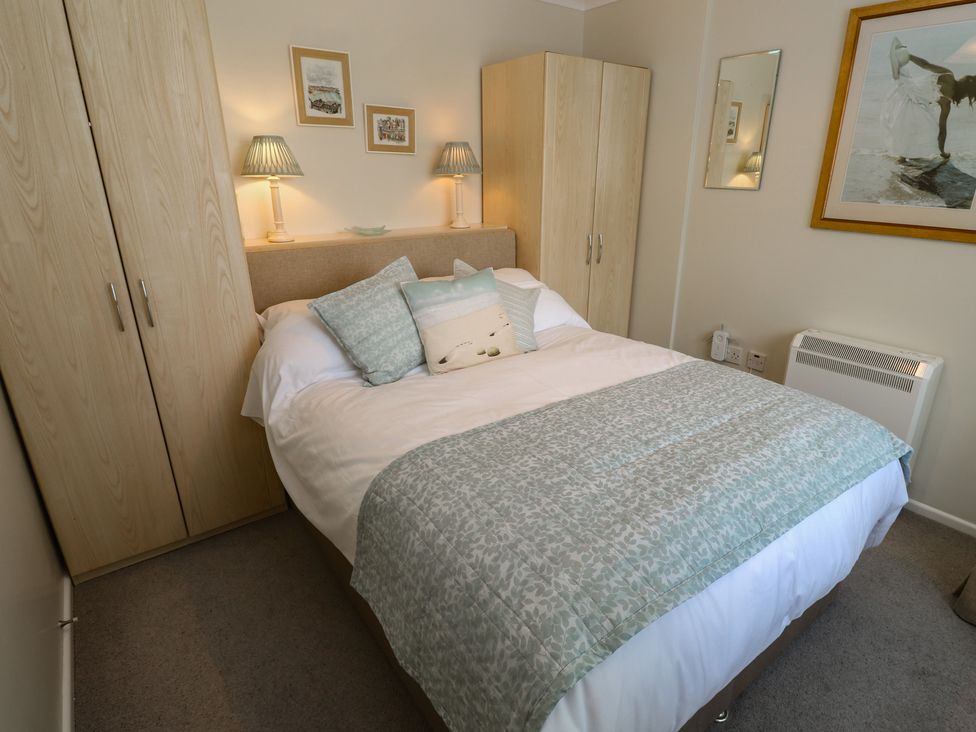 A bedroom with a bed and wardrobe at Bre An Mor in Praa Sands