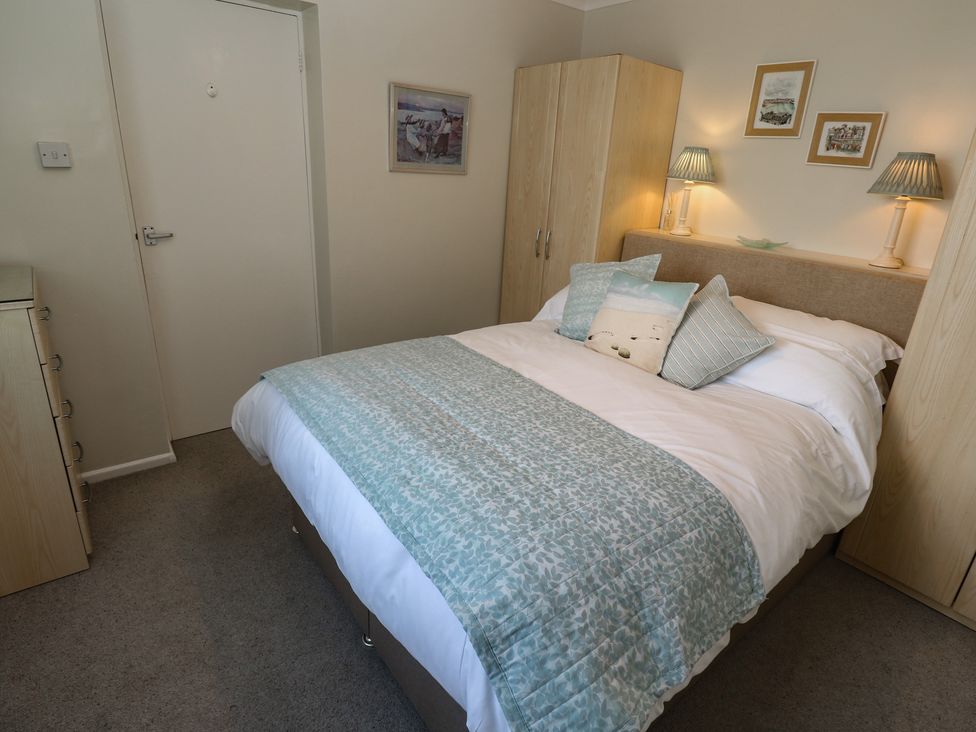 A bedroom with a bed and wardrobe at Bre An Mor in Praa Sands