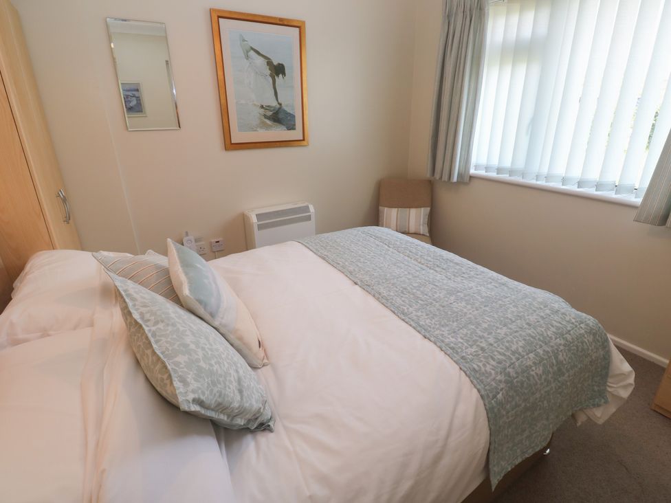 A bedroom with a bed and a chair at Bre An Mor in Praa Sands