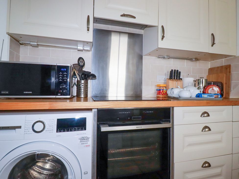 A kitchen with appliances and utensils at Penrose Farm Cottage St Keverne