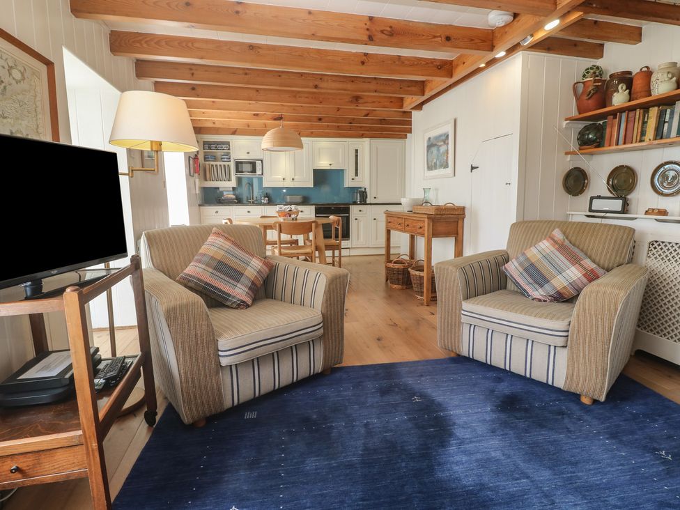 A living room with chairs and a television at Pegs in Porthleven