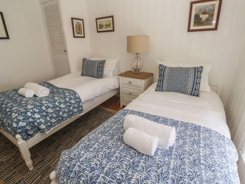 A bedroom with twin beds and a bedside table at Pegs in Porthleven