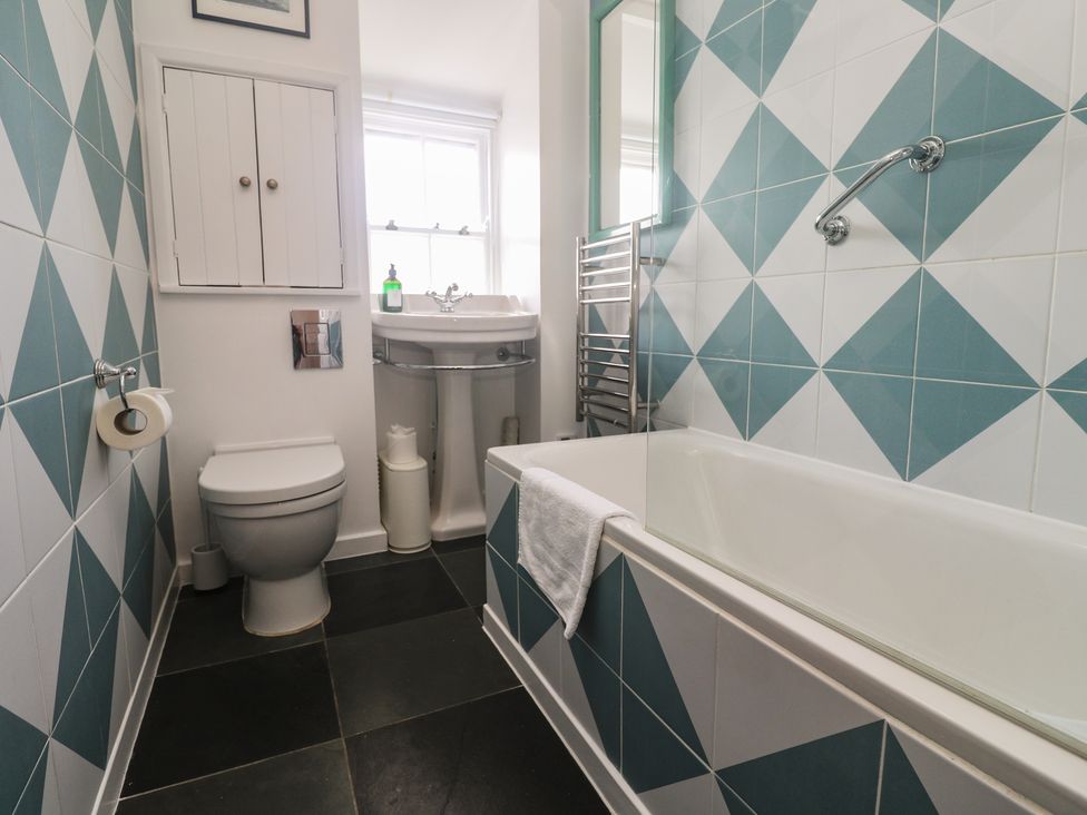 A bathroom with a toilet, sink, and bathtub at Pegs in Porthleven