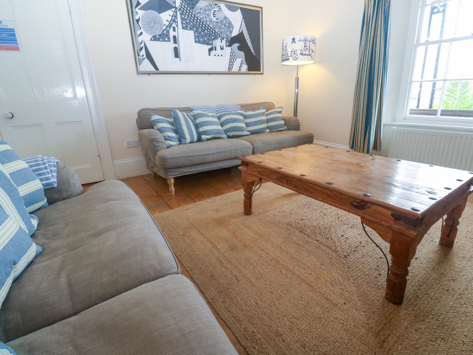 A living room with a sofa and coffee table at 1 Dormer Villas in Portscatho