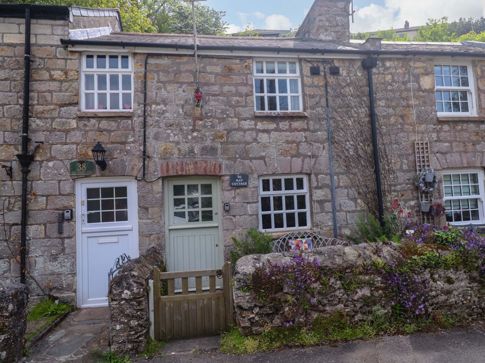 Two stone cottages with doors and windows at May Cottage Pentewan