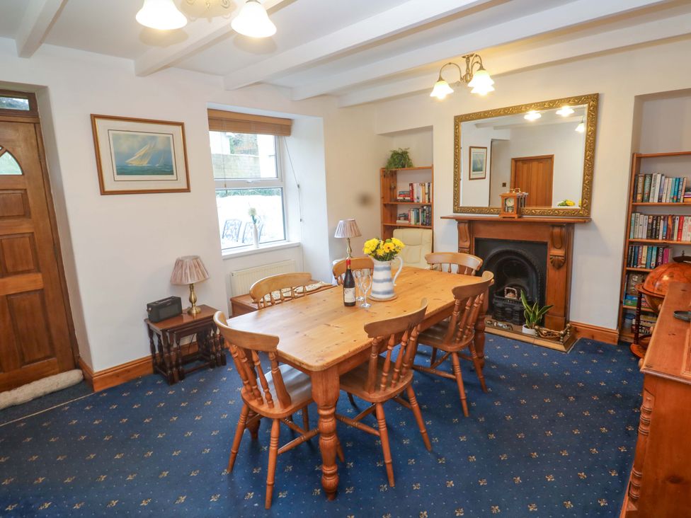 A dining room with a table and chairs at Angarrack Farmhouse in Hayle
