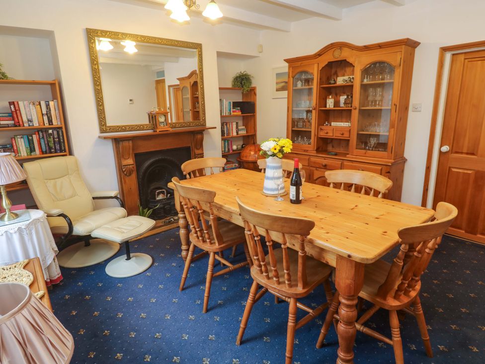 A dining room with a wooden table and chairs at Angarrack Farmhouse in Hayle