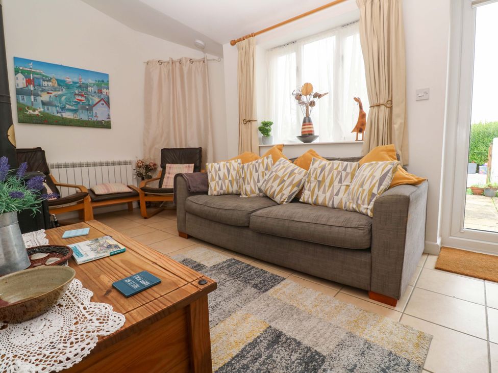 A living room with a sofa and coffee table at Godrevy Cottage in Hayle