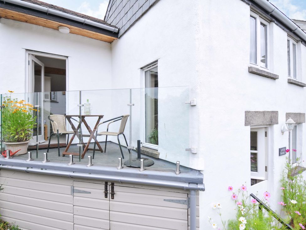 An outdoor patio with a table and chairs at Little Hamlin in Rilla Mill Nr Callington
