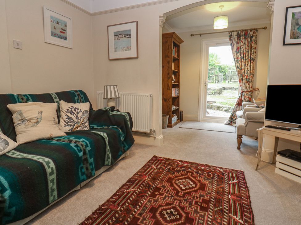 A living room with a sofa and television at Banneth in Helford