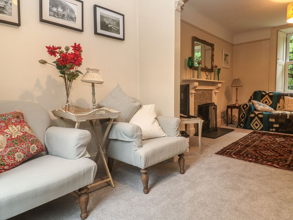 A living room with a sofa and table at Banneth in Helford