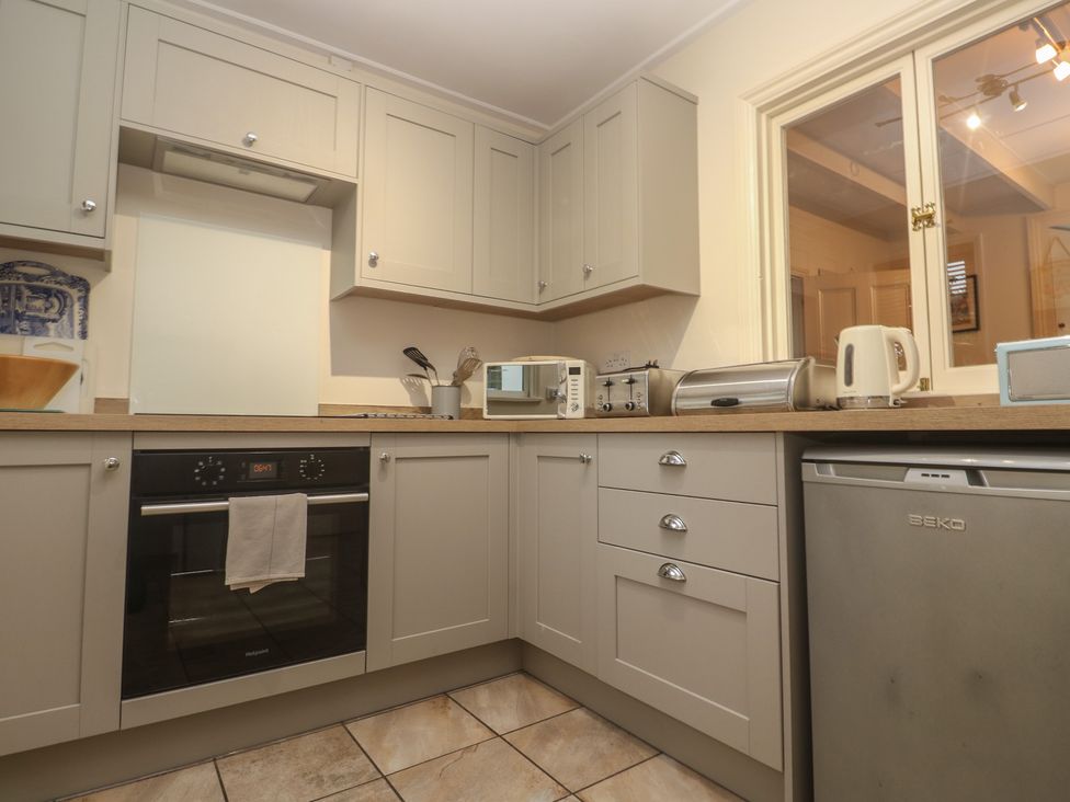 A kitchen with cabinets and appliances at Banneth in Helford