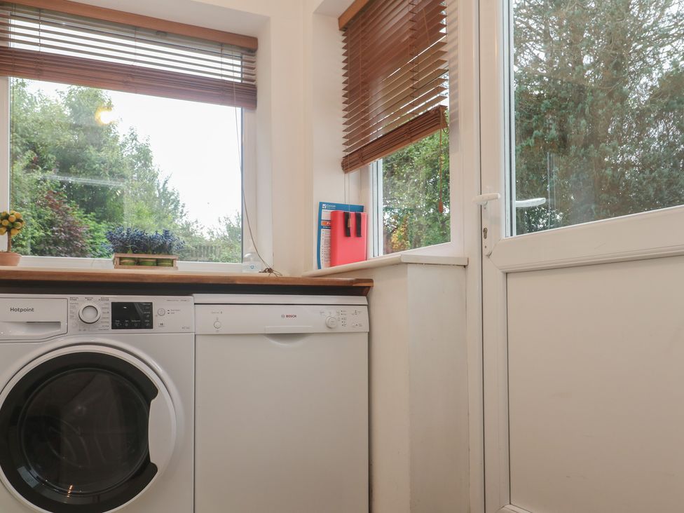 A utility room with a washing machine and a dishwasher at Banneth in Helford