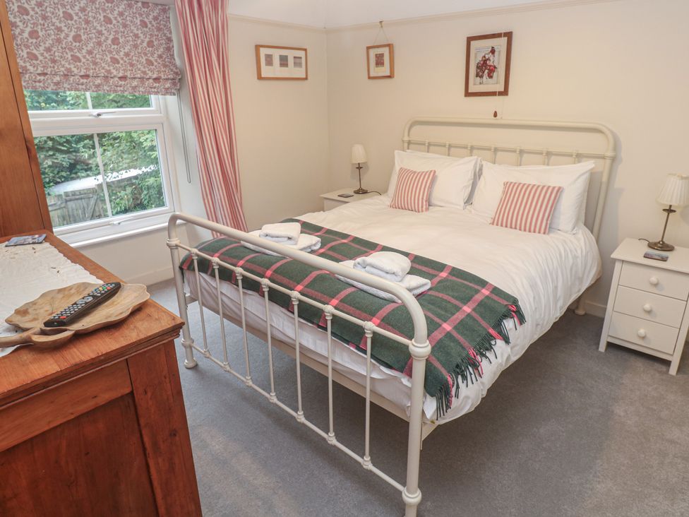 A bedroom with a bed and side tables at Banneth in Helford