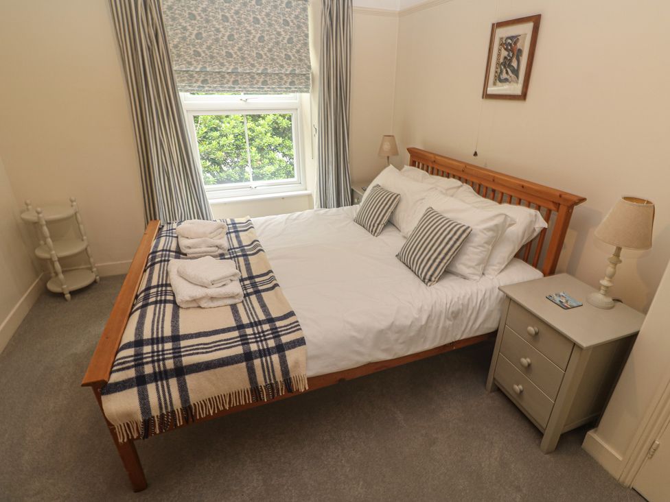 A bedroom with a bed and bedside lamp at Banneth in Helford