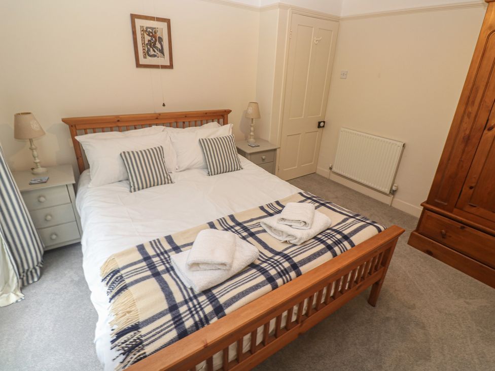 A bedroom with a bed and wardrobe at Banneth in Helford