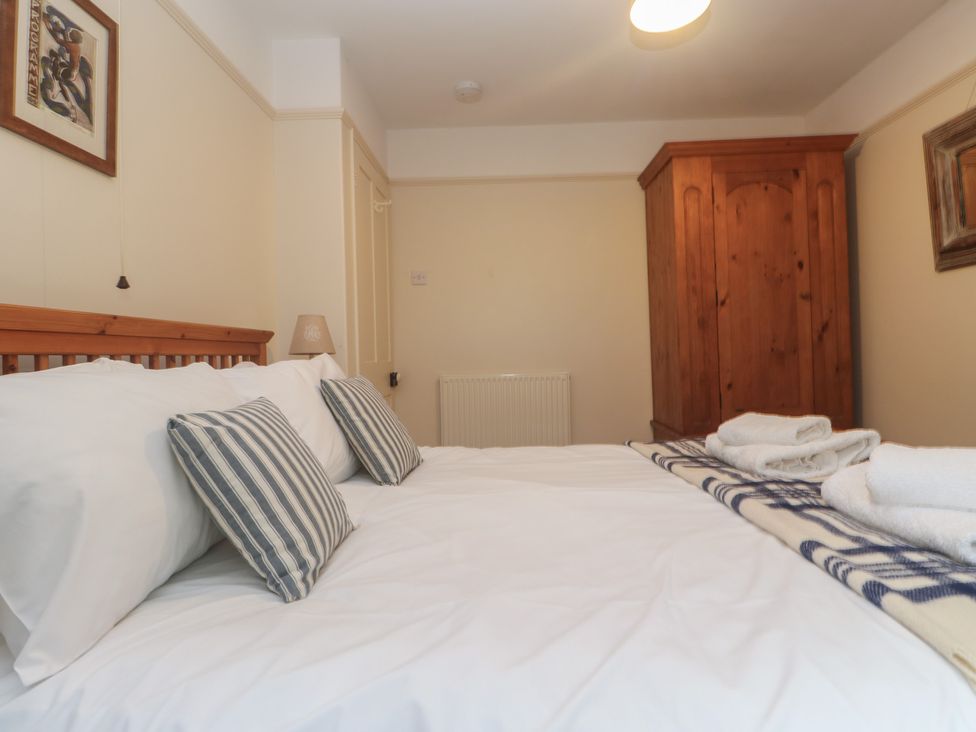 A bedroom with a bed and wardrobe at Banneth in Helford