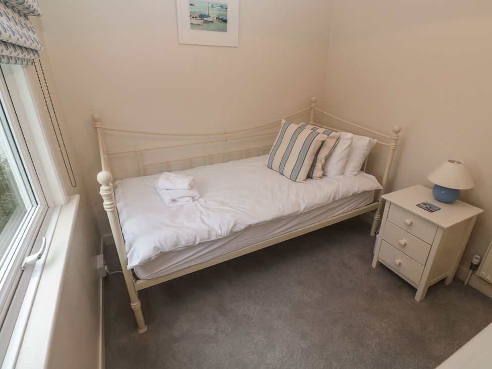 A bedroom with a single bed and a nightstand at Banneth in Helford