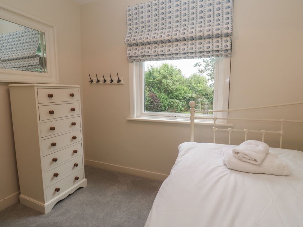A bedroom with a bed and wardrobe at Banneth in Helford
