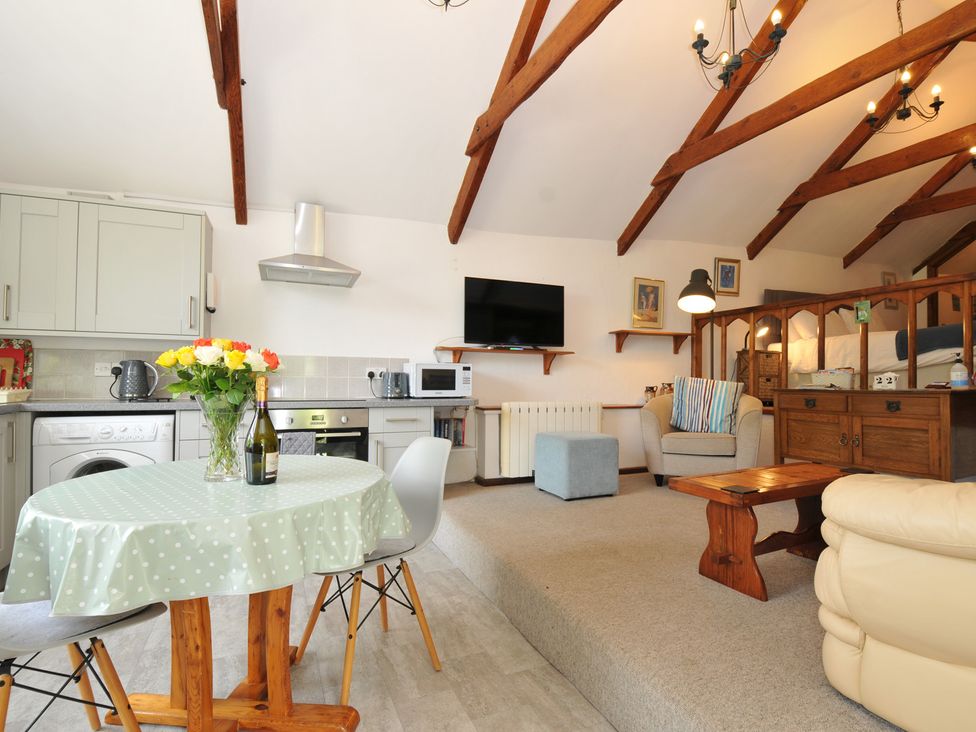 A living room with a table and chairs at Trevenning Chapel near Port Isaac