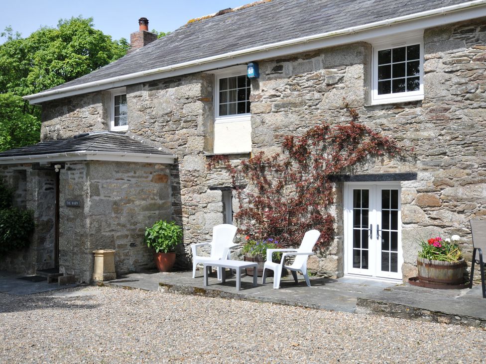 An outdoor area with chairs and planters at Trevenning Barn near Port Isaac