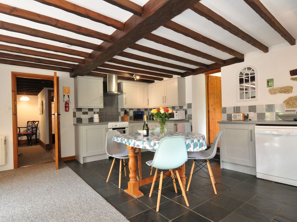 A kitchen with a dining table in Trevenning Barn Near Port Isaac