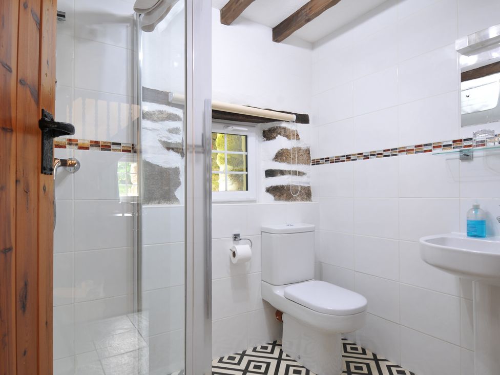 A bathroom with a shower and sink at Trevenning Barn Near Port Isaac